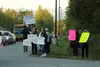 Anti-mask protesters stand in front of Teeland Middle School Tuesday. Tim Rockey / Frontiersman
