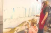 Photo courtesy of Suzanne Bach Marina Angel, left, adds color to
a student mural project at Mat-Su College. The finished project
will be donated to the Musk Ox Farm in Palmer as part of renov