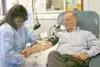 MATT TUNSETH/Frontiersman Alaska Blood Bank technician Cynthia
Watts takes a donation from Wasilla resident Ed Lamm, who is the
state’s top blood donor at 89 gallons. His Thursday donation wa