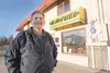 Ken More stands in front of the K&amp;A Fuel building along the Glenn Highway Saturday afternoon. More, along with business partner Art Wikle, own Artic’s Air Academy and have recently expand