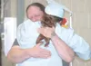 GREG JOHNSON/Frontiersman Jeff Oster shares an emotional hug
with son Brighton Lester Tuesday at the Burchell High School
graduation ceremony.