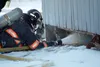 A Houston Fire Department firefighter sprays water beneath a cabin alongside the Parks Highway in Houston on Friday. A department spokesman said a heat lamp used to thaw pipes was the likely 