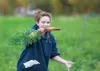 Tristain Burgess, 14, holds up a large carrot she picked
Saturday afternoon at Pyrah's Pioneer Peak Farm Fall Harvest
Festival. (ROBERT DeBERRY/Frontiersman)