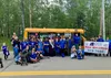 CCS Early Learning staff members pose for a photo in front of a bus. Courtesy photo.