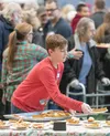 Hatcher Mattingley, Big Lake, puts out desserts for guests in his third year of volunteering at the Christmas Friendship Dinner. He was there with his father Ryan. J. David McChesney/Frontier