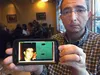 Erick Cordero holds a phone displaying a picture of his brother, Victor Hugo Cordero, who has been held since 2012 in a Mexican prison. His brother was a police chief in the Mexican state of 