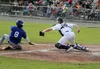 Mat-Su Miners catcher Sam Thompson tries to put the tag on Anchorage’s Malcom Tipler in 2019. Jeremiah Bartz/Frontiersman