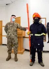 U.S. Air Force Airmen 1st Class Timothy Beffa and Jose Tapia-Borbon, both 773d Civil Engineer Squadron electric systems technicians, demonstrate their equipment during a 773d CES immersion to