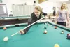 Sydney Egbert, 12, lines up a shot while friend Lily Birch, 10,
waits her turn during a game of pool Monday at the Boys and Girls
Club on Bogard Road. The doors are still open at the Valley c