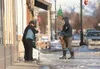Denise Statz and her son, Kurt, chip and remove ice from the
sidewalk in front of their store, NonEssentials, in downtown Palmer
Thursday morning. Warmer temperatures during the day and freez