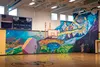 Artists Bill Barstow and Tony Crocetto painted this awesome climbing wall mural at Susitna Valley High School. Courtesy Ed O’Connor