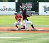 Wasilla infielder Ryan Perkins tries to catch the ball on a hop as Ketchikan's Mo Bullock slides back into second base during Ketchikan's first-round state baseball win over Wasilla June 2, 2
