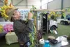 Rouhan Ricker works on the final touches at the Avant Gardens
Mobile Green House booth during set up at the 4th Annual Fall Home
Show Thursday afternoon at the Curtis D. menard Memorial Sport