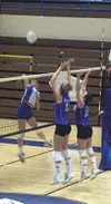 Palmer seniors Emily Sakis and Brianna Johnson leap for a block
in Palmer's 3-1 win over the visiting Homer Mariners Tuesday in the
final conference match of the regular season for the Moose.