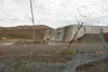 A dilapidated fence hangs in front of the missile launch and storage area at Nike Site Summit, at Joint Base Elmendorf-Richardson Sept. 9. Nike Site Summit was constructed in 1959 as a respon
