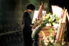 Eileen Burnley stands in front of the casket of her late husband
Dr. Kenneth Stephen Burnley during the celebration of his life at
Teeland Middle School in July. ROBERT DeBERRY/Frontiersman