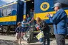 Alaska State Fair CEO Jeff Curtis (far right) and Kelly Larson, the ASF Director of Community and Corporate Partnerships, welcome guests coming to the fair on Alaska Railroad's first train fr