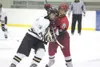 ROBERT DeBERRY/Frontiersman Wasilla senior forward Eric Johnson
checks South Wolverine Kyle Lindberg during the third period of
Thursday’s quarterfinal game at the 2011 First National Cup Sta