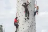 Children climb to the top of a rock-climbing wall at the Mountain View National Night Out in Anchorage, Alaska, Aug. 6, 2018. The event began in 1984 as a crime-prevention program to emphasiz