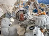 Col. Drew Morgan waves as he is photographed during a spacewalk to repair the Alpha Magnetic Spectrometer, a cosmic particle detector on the International Space Station, Nov. 15, 2019. The Ar