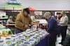 The Soap Lady owner Jackie Palmer, right, helps a customer with a lip balm purchase at the Palmer Depot Farm Market Dec. 7. The market is open Mondays from noon to 6 p.m. STEVEN MERRITT/Front