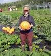 Glenna Gannon holds a large Lakota squash, a winter squash variety that thrives in Fairbanks. Gannon, an assistant professor at UAF, will present a gardening webinar today, the first in a Mar
