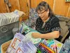 Cheryl Lacy works on an art project at her vendor booth. Jacob Mann/For the Frontiersman