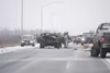 Morning commuters tend to the driver involved in a two vehicle
accident on the Glenn Highway Thursday morning. The late model
jeep, heading northbound lost control arond 8:30 am, crossed the

