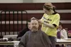 Kristen Mayer gives Jerry McKenzie a hair cut Wednesday
afternoon at the Curtis D. Menard Memorial Sports Center during the
first Mat-Su Homeless Connect event. (ROBERT
DeBERRY/Frontiersman)