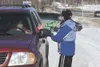 Coisman hands boxes of cookies to Janet Kincaid. ‘We figured
they have drive up wedding chapels in Las Vegas, so why not drive
up Girl Scout cookies?’ said Jennifer’s mom, Estella. (ROBERT
De