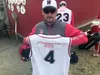 Wasilla Road Warriors American Legion head coach Ken Ottinger holds up his jersey, which includes the name of Kurtis Arcala on the back. Arcala is a 2001 graduate of Palmer High School who di