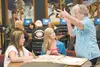 Wasilla Middle School seventh-graders Hailey Hotchkiss and Mackenzie Berensmann talk to longtime Valley resident Evelyn Mielke about her memories of the 1964 earthquake as part of a community
