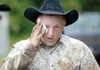 RP Morrison holds a rag to his face after he was kicked by a
steer during the double mugging competition. ROBERT
DeBERRY/Frontiersman