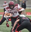 Houston's Mark Kudryn takes on a tackle from Kenai Central's Owen Whicker on Saturday, Sept. 24, 2022, at Ed Hollier Field at Kenai Central High School in Kenai, Alaska. Jeff Helminiak/Penins