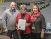 Mayor Glenda Ledford holds the Proclamation Recognizing the 50th Anniversary of the Incorporation of the City of Wasilla with Wasilla Police Chief Rapson (L) and City Clerk Jamie Newman.