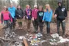 River Rangers examine trash left along the river before their cleanup efforts. Courtesy photo