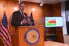 Alaska Gov. Mike Dunleavy speaks during a news conference in Juneau on Thursday, April 27, 2023. To his side is a screen displaying significant budget deficits and exhausted savings accounts 