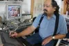 Mariano Gonzales, an associate professor of art at the
University of Alaska-Anchorage, works at his home in Peters Creek
on an art piece he created called "The Garden." Gonzales, a digital
de