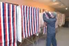 Koby Perkins sets up voting booths Monday inside the Wasilla
City Council chamber in preparation for today's general election.
(ROBERT DeBERRY/Frontiersman)