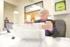 ROBERT DeBERRY/Frontiersman Election worker Gerry Keeling checks
the names of residents who voted by absentee ballot at the
Matanuska-Susitna Borough building in Palmer.