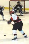 Houston's Lucas Van Buskirk sends a slap shot on the Monroe goal
during the second period of Tuesday's game at Brett Memorial Ice
Arena. TIM BRODT/Frontiersman