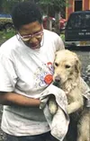Lesia Turner brings out another of the dogs. The animals are
currently being held at the shelter and checked for health and
adoptability. Photo by RINDI WHITE/Frontiersman.