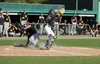 Anchorage's Dominic Collachio slides in behind Mat-Su catcher Ryan Haug during a 4-0 win over the Miners in the first game of the best-of-3 Alaska Baseball League Top of the World Series Frid