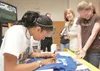 ROBERT DeBERRY/Frontiersman Jessica Moore signs an autograph for
sixth-grader Kady Clark at Palmer Junior Middle School on Monday.
Moore, a professional basketball player who was once a stude