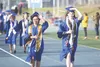 Class speaker Marcellina Fagaltinmad waves to the crowd during the procession of the Palmer High School graduation May 19 at Machetanz Field. Jeremiah Bartz/Frontiersman