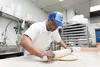 Kamal Grant rolls the dough at Sublime Doughnuts Monica Farber