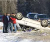 Joseph Price gets a thank you hug from the mother of the female
driver involved in a single car rollover on Bogard Road Saturday
afternoon. The sedan lost control and left the icy roadway on 