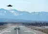 A U.S. Air Force F-22 Raptor takes off while other Raptors taxi to the runway following a close formation taxi known as an elephant walk, at Joint Base Elmendorf-Richardson, Alaska, May 5, 20