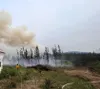 Firefighter stands watch while crews conduct burnout operations to protect a structure. Photo by Cody Platz, firefighter with Northwest Team 10