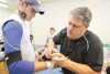ROBERT DeBERRY/Frontiersman For Palmer Moose Thorton DePriest
and team athletic trainer Brian Larson game preperation begins in
the Palmer Moose locker room with taping of arms, legs, wrists,